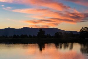 photo of person riding kayak during dawn