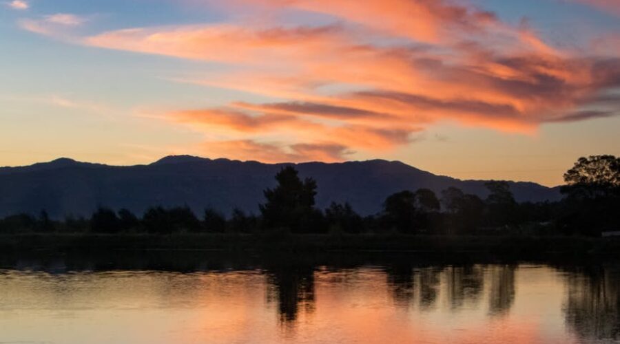 photo of person riding kayak during dawn