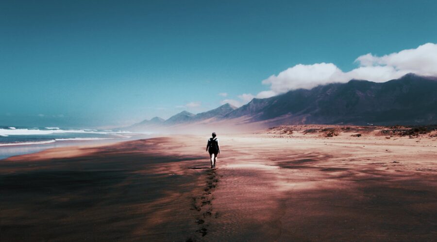 photo of person walking on deserted island