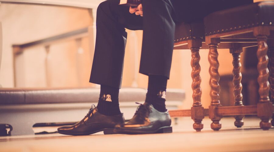 person sitting on a chair holding book