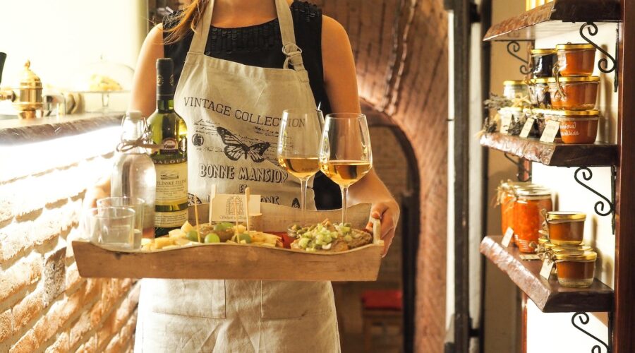 woman holding tray of wines