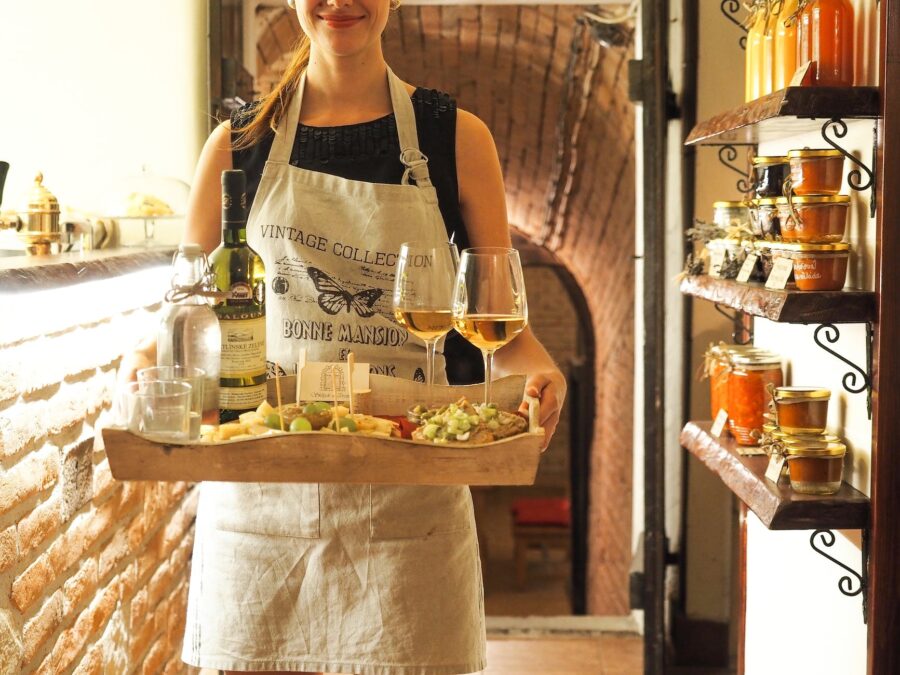 woman holding tray of wines